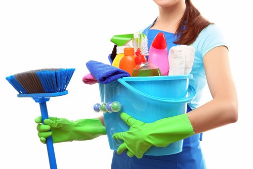 Cleaning kitchen surfaces and fixtures after renovation work in W8